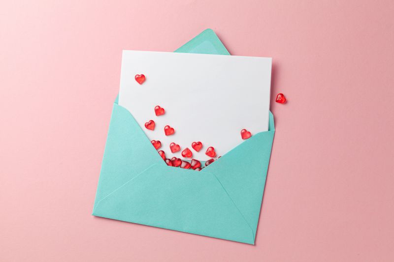 Love letter with hearts on pink background