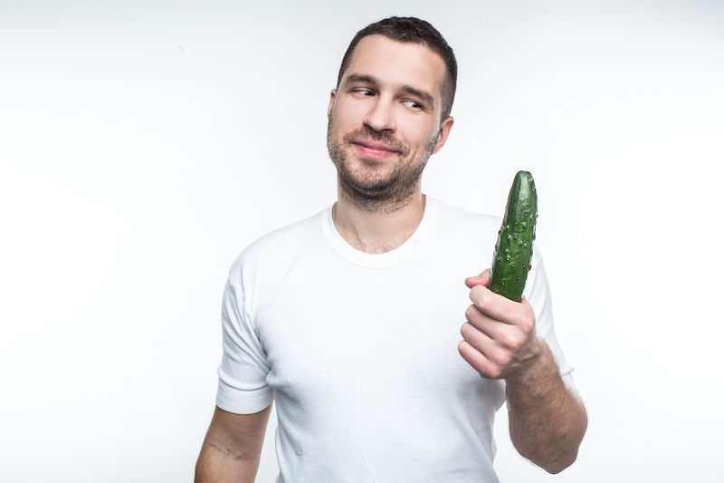 Man holding a cucumber