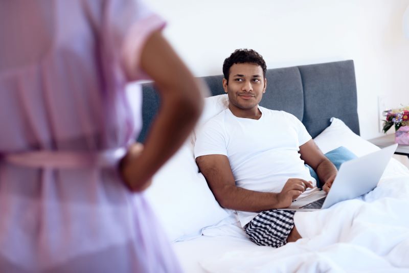 Man in bed with laptop