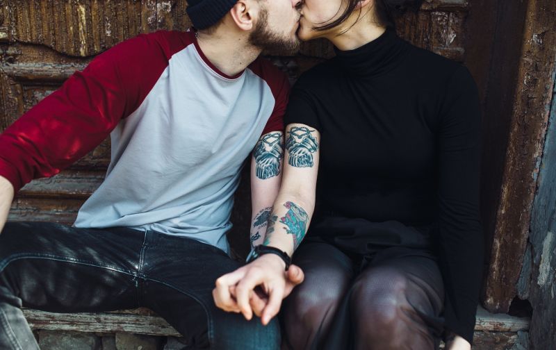 Modern couple holding hands and kissing