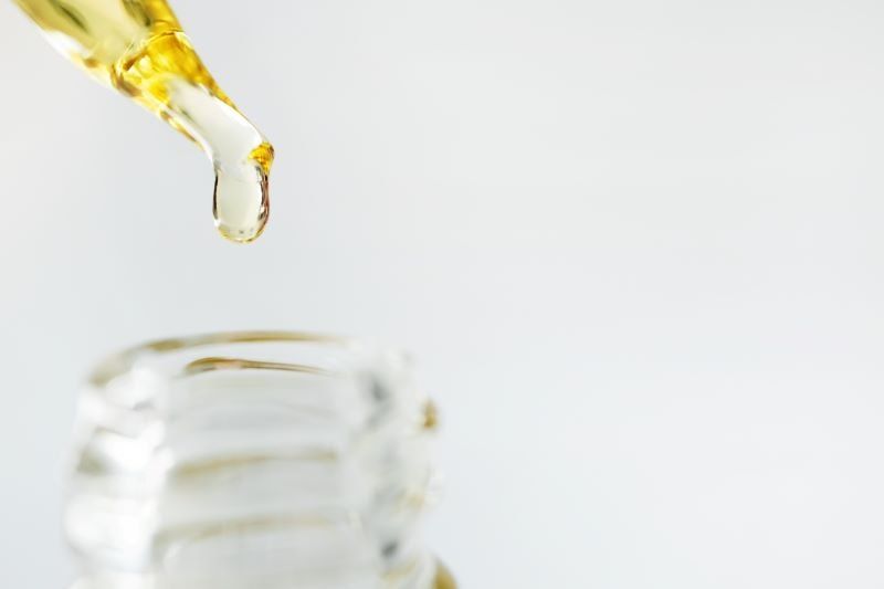 Oil being poured into glass bottle