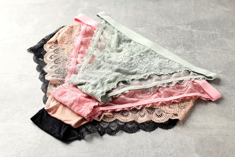 Pairs of female panties on textured surface