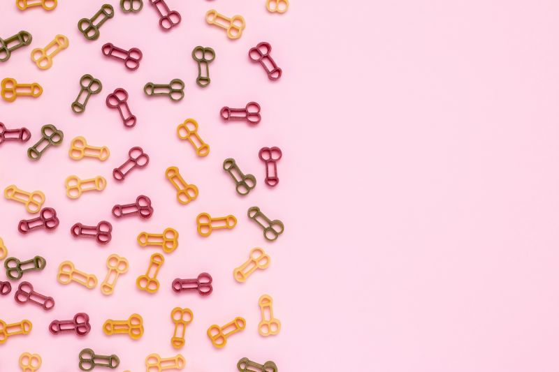 Penis shaped pasta on pink background