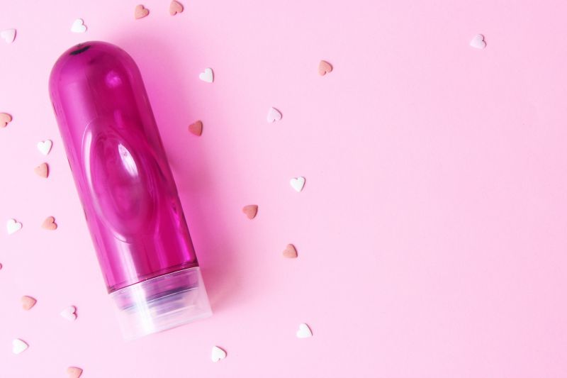 Pink lubricant bottle on pink background