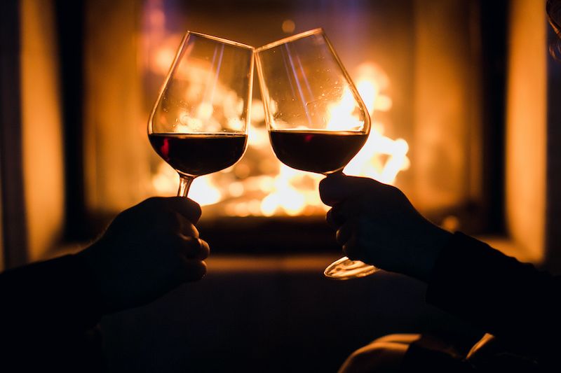 Romantic dinner wine glasses and fire