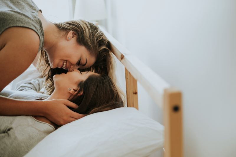 Romantic happy couple kissing in bed
