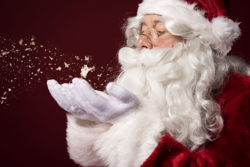 Santa claus blowing flakes