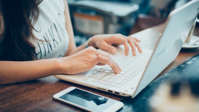 woman tipping in her computer selling her panties