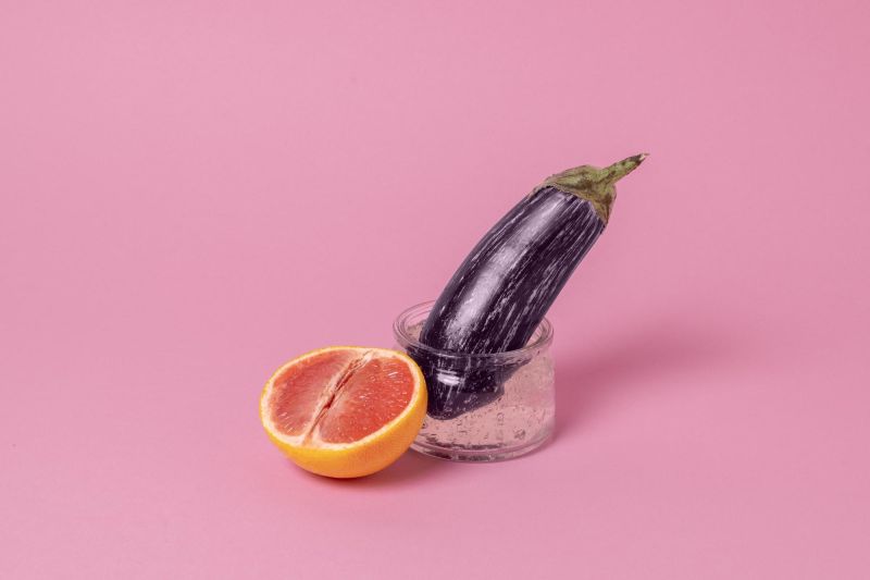 Sex concept with eggplant and grapefruit