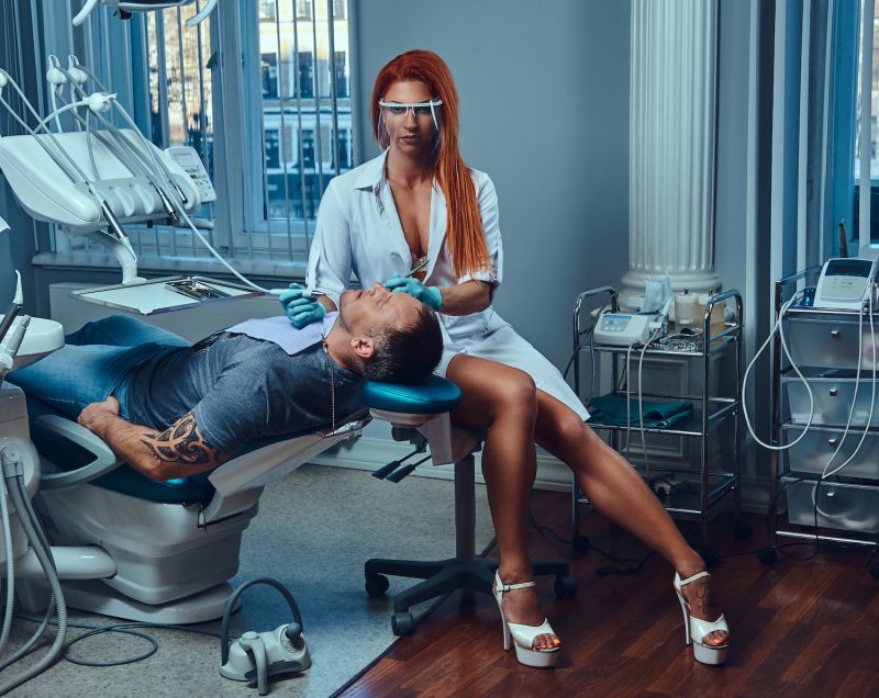 Sexy female dentist with patient