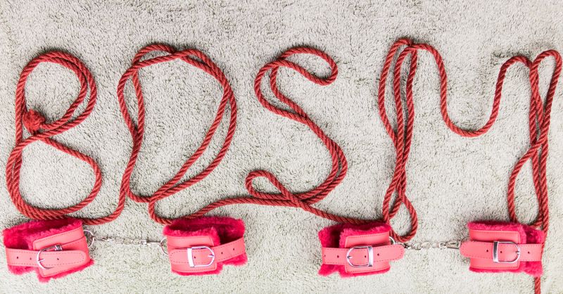 Red shibari rope spelling BDSM