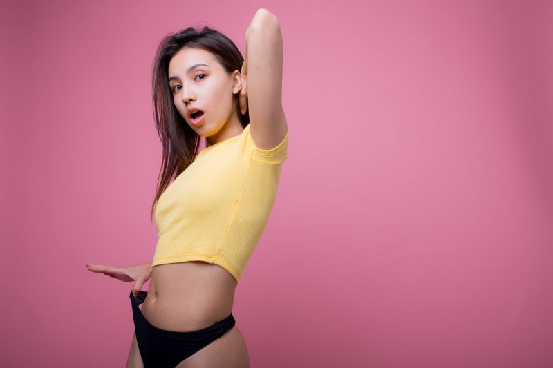 Shocked posing woman pulling up panties