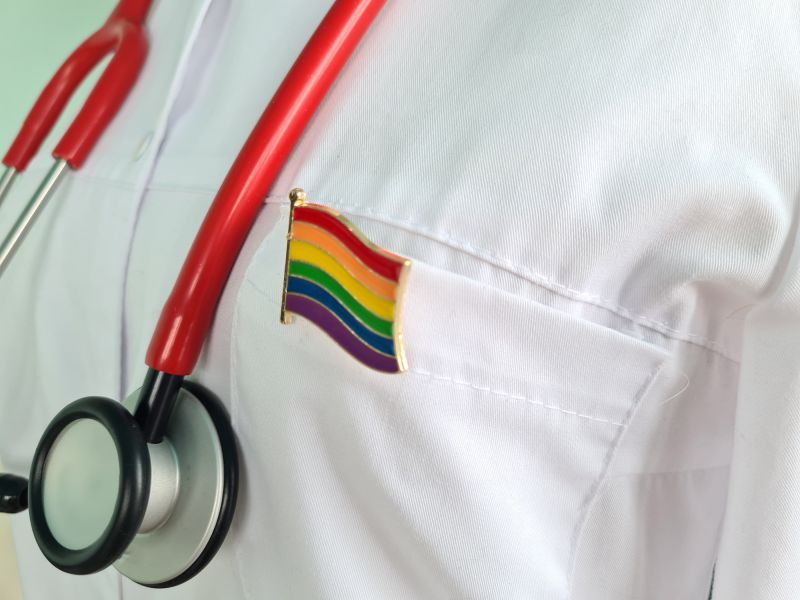 Silhouette doctor white coat stethoscope with lgbtq badge