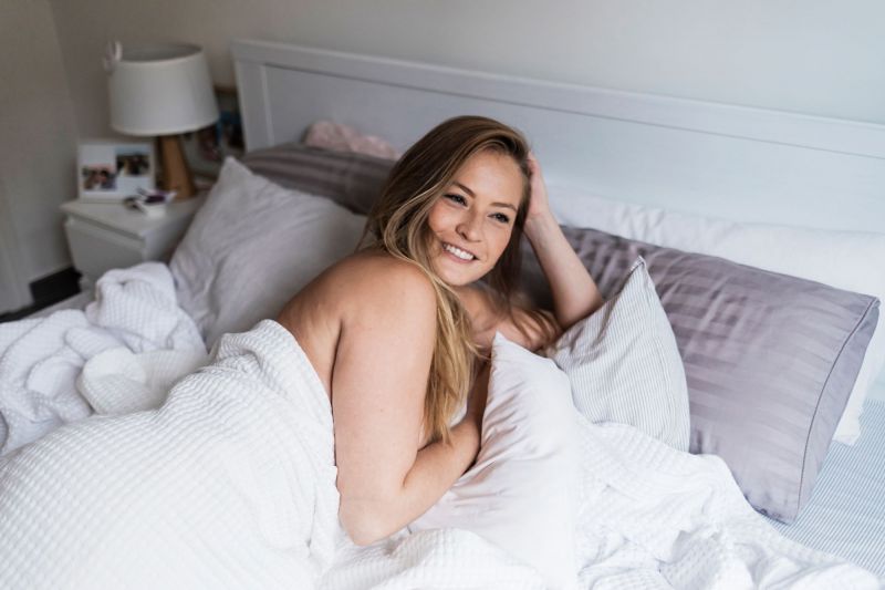 Smiling woman in bed in the morning