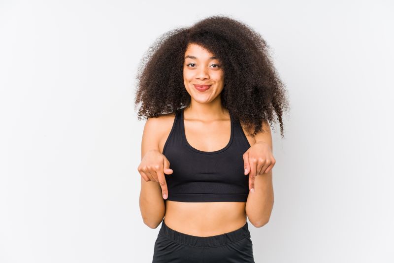 Woman in sportswear pointing down