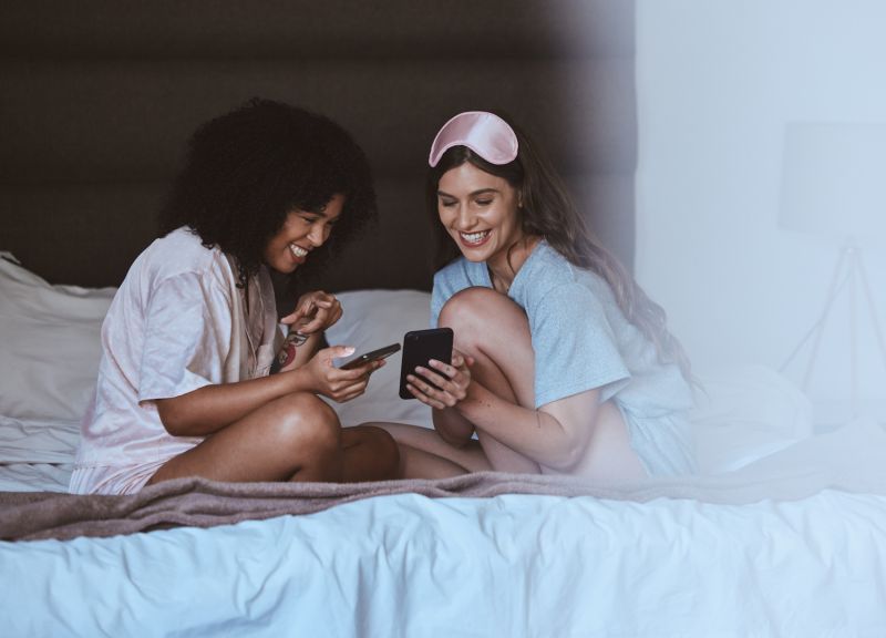 Smiling women having slumber party at home