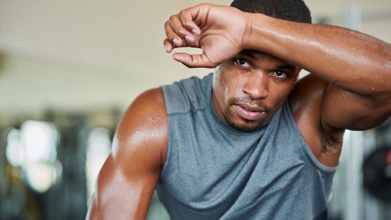 athlete wiping sweat from forehead