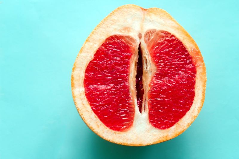 Half a grape fruit on blue background