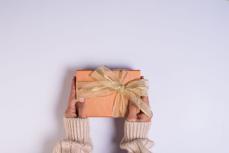 Top view of hands holding gift box