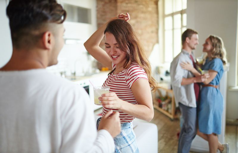 Two couples dancing at home