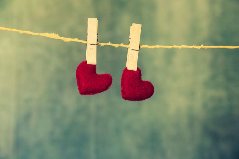 Two pegs holding hearts