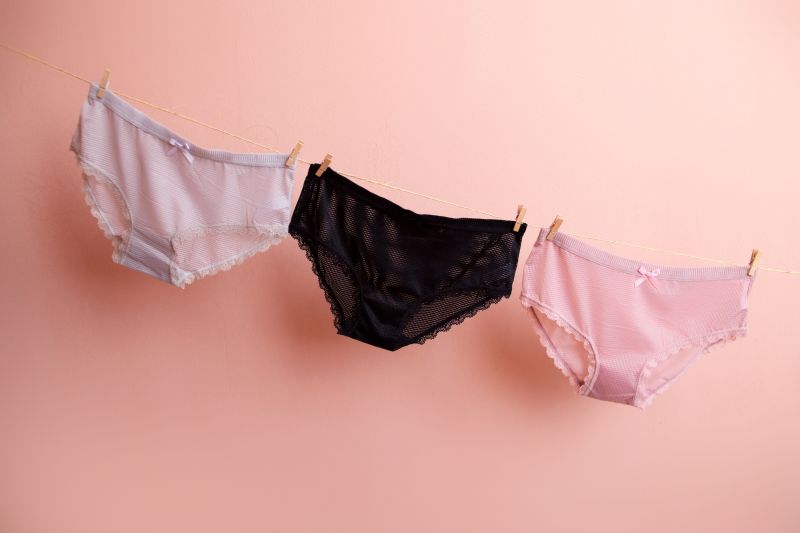 Underwear hanging on pink background