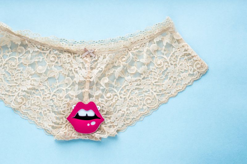 White panties on blue background with pink lips graphic on top