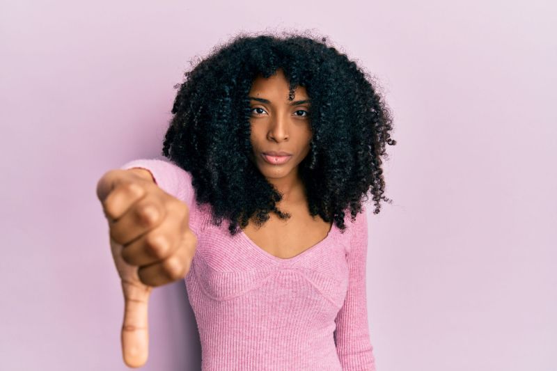 Woman doing thumbs down sign