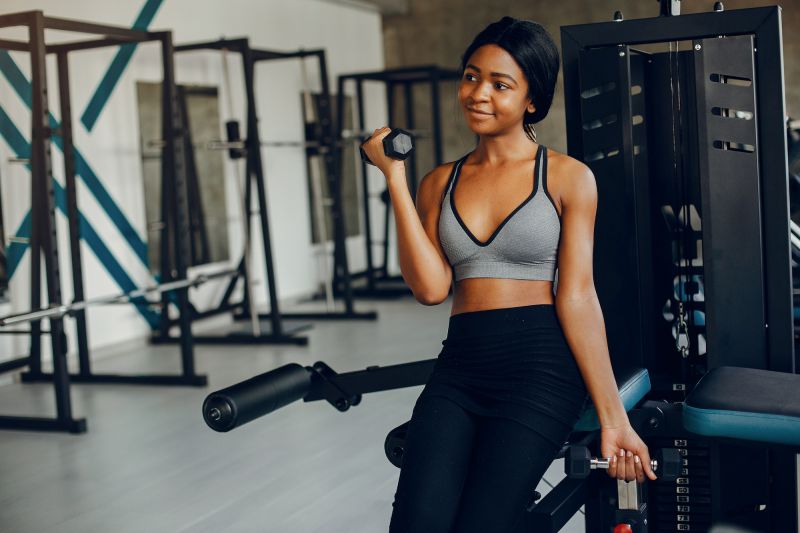 Woman doing weight exercises in gym