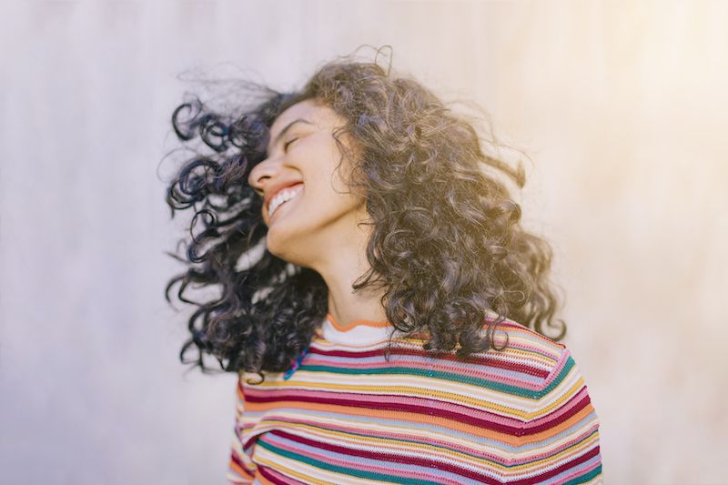 Happy woman throwing her head back