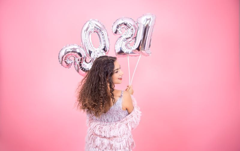 Woman holding 2021 balloon