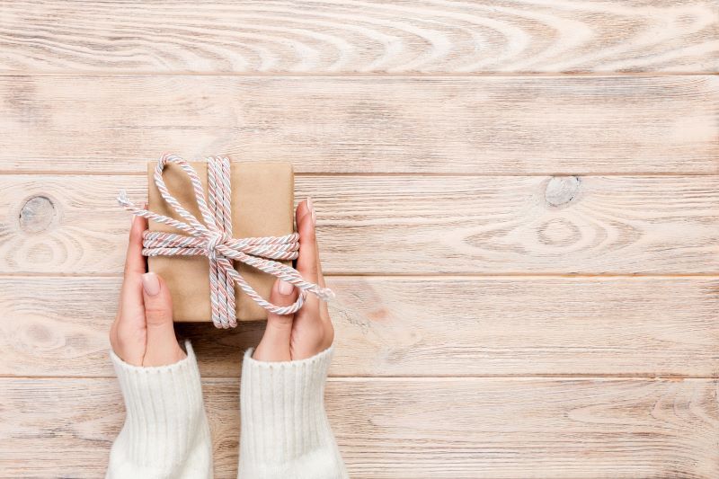 Female hands holding gift