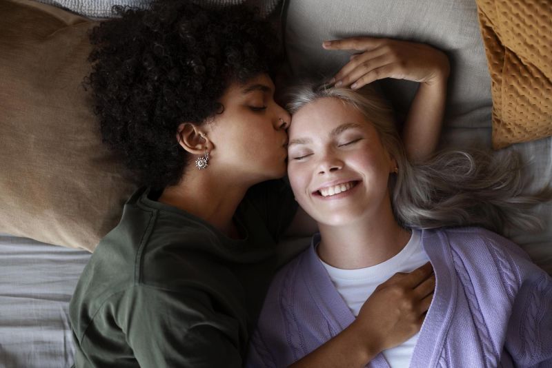 Woman kissing girlfriend at home