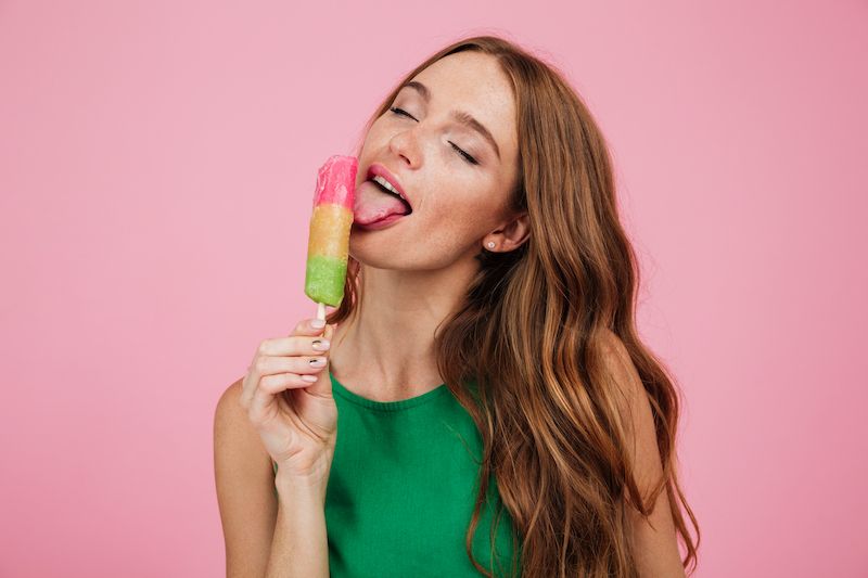 Woman licking lollipop