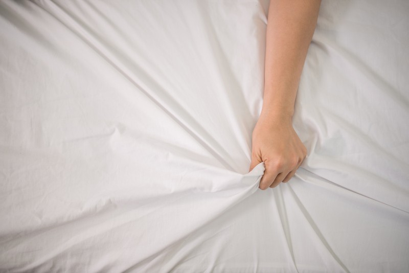 Woman hand grabbing sheets