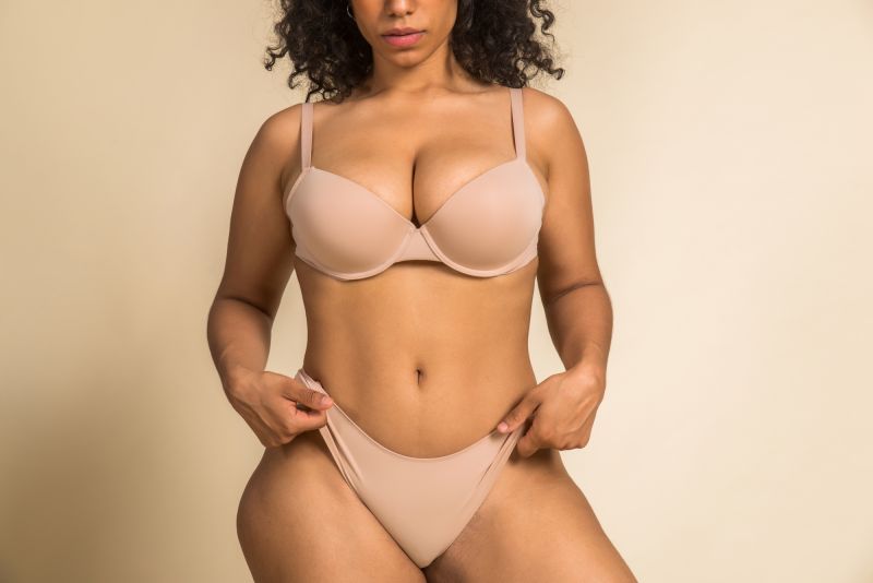 Woman posing in beige underwear