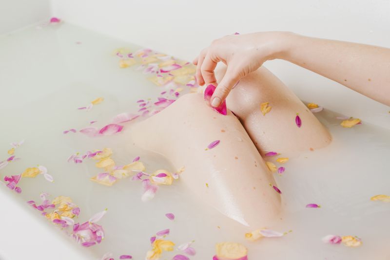 Woman relaxing in bath with flowers