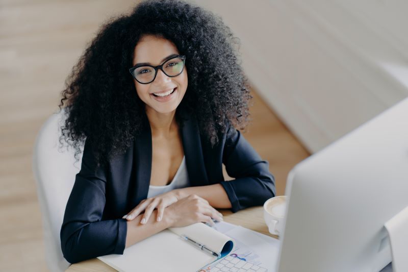 Woman smiling on her laptop