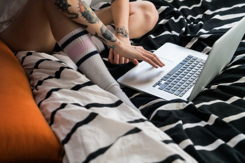 Woman using laptop in bed