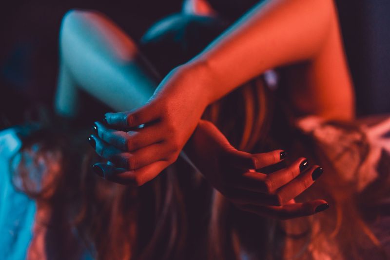 Womans arms close up red light