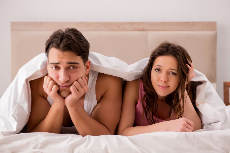 Worried couple in bed