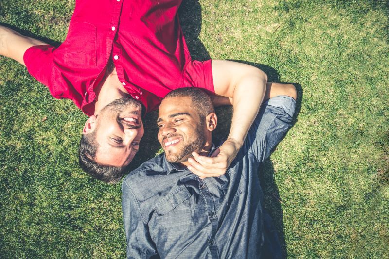 Happy couple lying on the grass