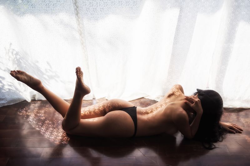 Woman lying on floor in lingerie