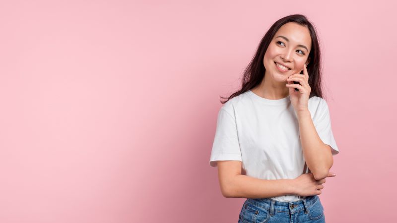 Young woman thinking and smiling