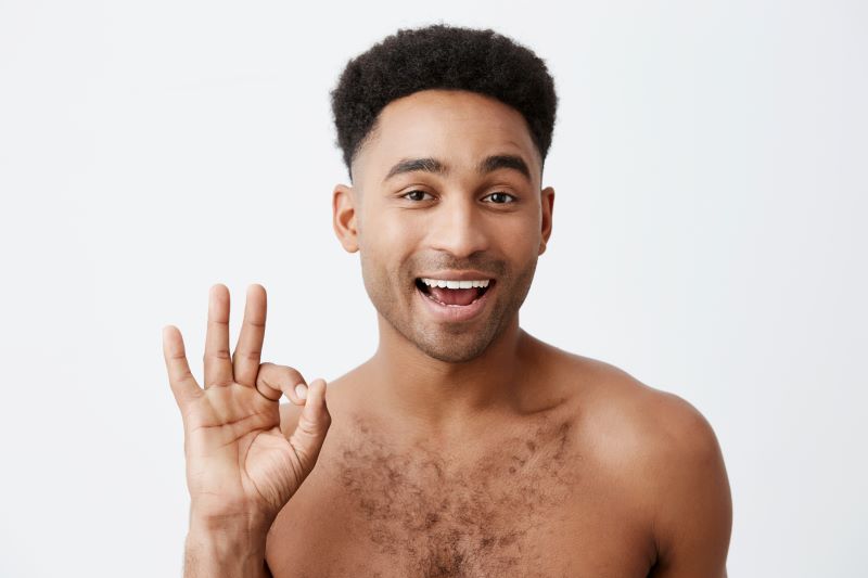 Smiling man making OK hand sign