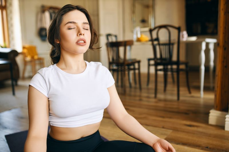 Woman meditating at home