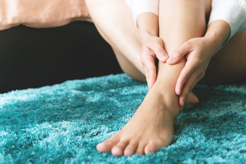 Woman giving herself foot rub