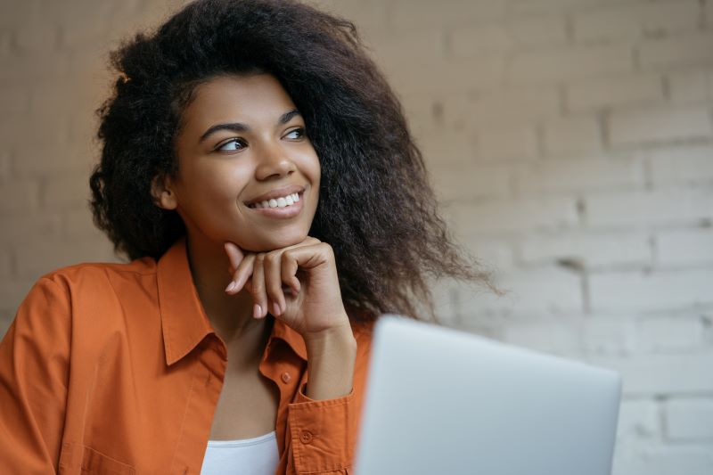 Woman on laptop smiling