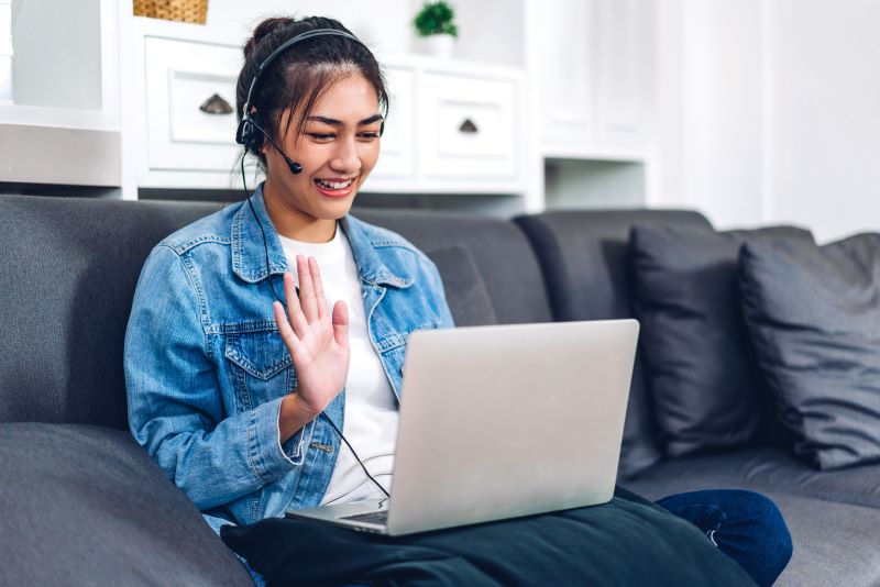 Woman waving on video call