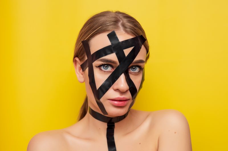 Woman with latex tape on her face